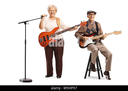 Full length portrait of an elderly man and woman with guitars and a microphone isolated on white background Stock Photo