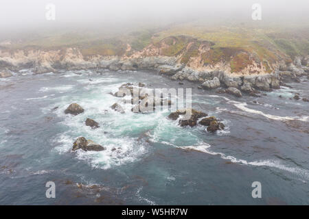 Seen from a bird's eye view, the Pacific Ocean washes against the scenic and rocky coast south of Monterey in Northern California.