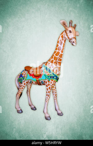Carnival carousel giraffe isolated on green background Stock Photo