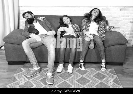 Exhausting cleaning day. Family mom dad and daughter with cleaning supplies sit on couch. Family care about cleanliness. Finish cleaning. Cleaning all day exhausting occupation. Tired parents and kid. Stock Photo