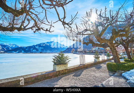 Enjoy the day walk by Zeller see lake, surrounded by gardens, parks, tourist hotels and townhouses of Zell am See, Austria Stock Photo