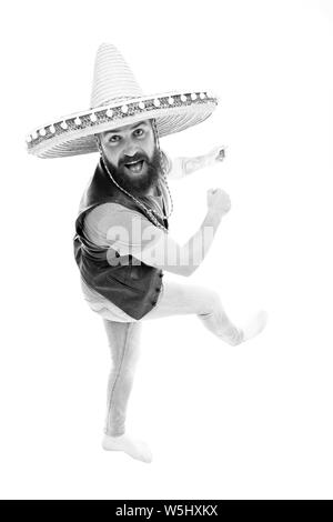 Mexican energetic temper. Man bearded cheerful guy wear sombrero mexican hat. Mexican party concept. Celebrate traditional mexican holiday. Guy happy cheerful face having fun dancing and jumping. Stock Photo