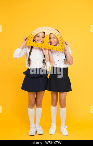 Discover mathematics patterns. Mathematical theory combining algebraic and geometric methods. School students study geometry. Pupil school girls big rulers. School knowledge. Explore world with math. Stock Photo