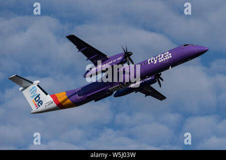 A Flybe De Havilland Canada Dash 8 Q400 takes off from Manchester International Airport (Editorial use only) Stock Photo