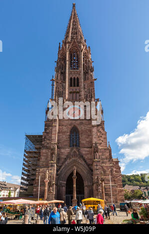 Freiburg Minster surrounded by farmers market Stock Photo