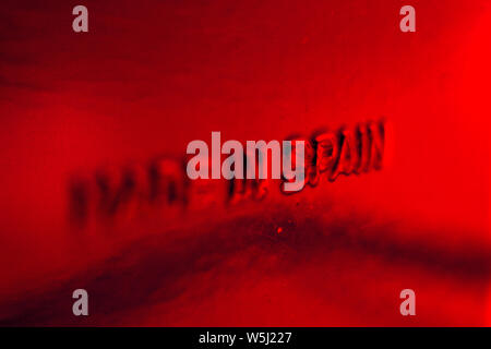 Made in Spain, inscription printed on red plastic surface, close-up Stock Photo