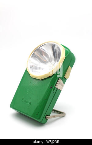 Vintage green metal flashlight torch, isolated on a white background Stock Photo