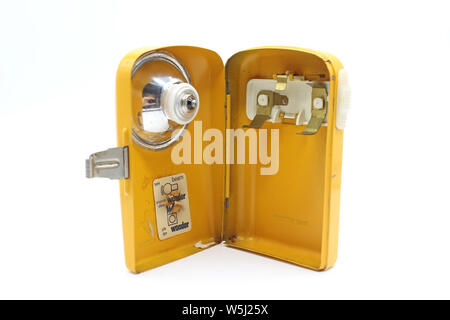 Vintage yellow metal torch flashlight open inside, isolated on a white background Stock Photo