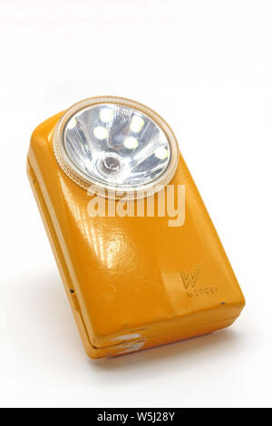 Vintage yellow metal torch flashlight isolated on a white background Stock Photo