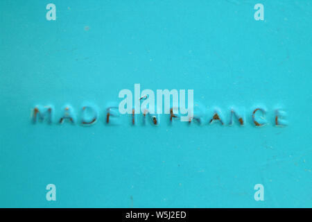 Made in France, inscription printed on red plastic surface, close-up Stock Photo