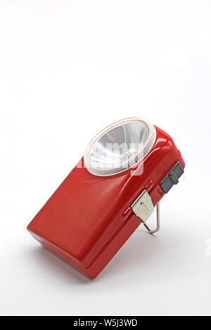 Vintage metal orange flashlight torch, isolated on a white background Stock Photo