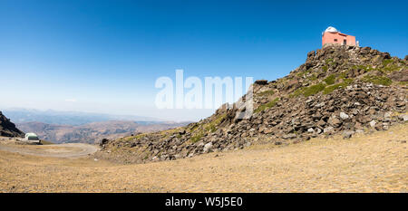 Panoramic view  Hoya de la Mora, Sierra Nevada, with old restored 1902 observatory Mojon del Trigo, reflector telescope, Andalusia, Spain. Stock Photo