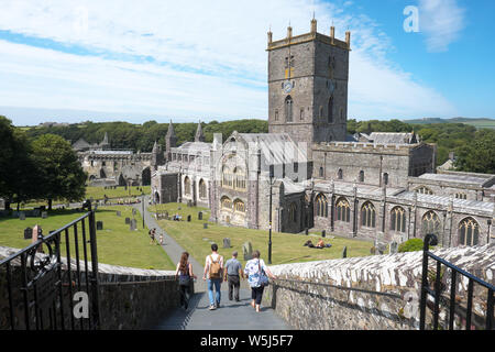 Tourists and visitors at St David's Cathedral in St Davids City Pemrokshire Wales summer 2019 Stock Photo