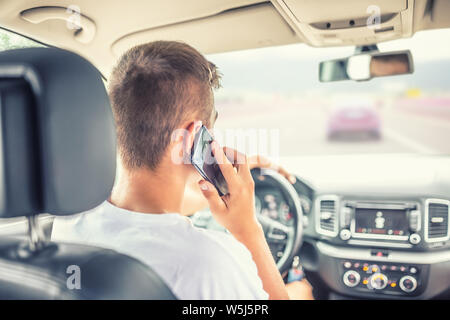 Man driving car and calling  from smartphone. Stock Photo