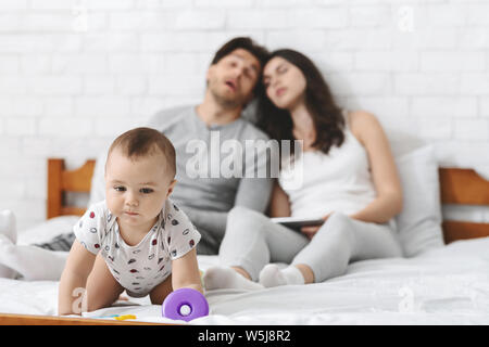 Baby risk of fall out of bed, crawling to side Stock Photo