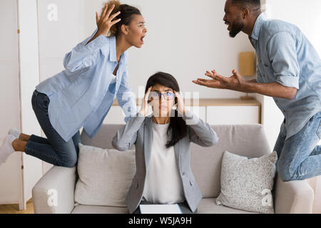 Shocked Marriage Counselor Watching Her Afro Patients Quarrelling In Office Stock Photo