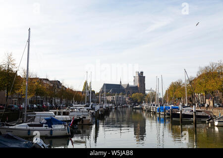 The Grote Kerk (Onze-Lieve-Vrouwe-Kerk) seen from the Nieuwe Haven in Dordrecht, the Netherlands. The church has a leaning tower. Stock Photo