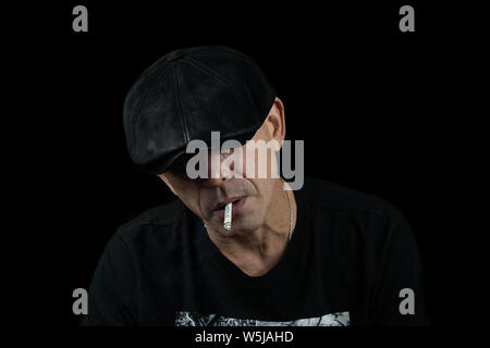 A handsome young man with a cigarette in the cloud of smoke Stock Photo