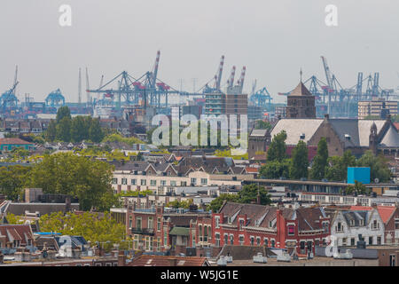 Rotterdam, the Netherlands - July 19 2019: mixed classic architecture of Rotterdam leafy urban apartment buildings in foreground with harbour waterfro Stock Photo