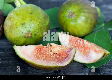 Fresh and juicy figs on a dark wooden table Stock Photo