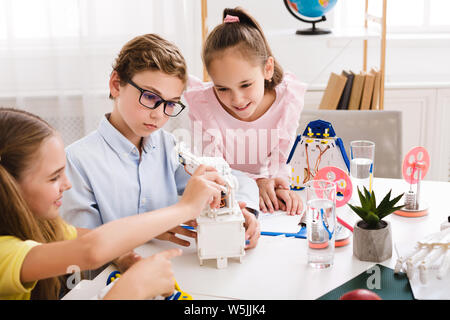 School boy and girl creating modern robot at stem class Stock Photo - Alamy