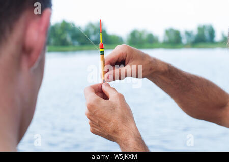 Father teaching son how to fishing in river Stock Photo