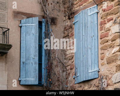 Two wooden windows, painted in blue, one close and the other semi closed, from a typical house of Gigondas, France Stock Photo