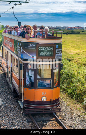 Seaton, South East Devon, England. Monday 29th July 2019. UK Weather.  With increasing cloud and stormy weather forecast for tomorrow, holidaymakers make the most of a trip on the Seaton Tramway, winner of the 'Silver Award 2016 for Large Attraction of the Year.' Credit: Terry Mathews/Alamy Live News Stock Photo