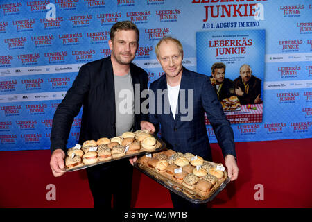 Munich, Germany. 29th July, 2019. The actors Sebastian Bezzel (l) and Simon Schwarz are on the red carpet at the premiere of the film 'Leberkäsjunkie' in the Mathäser Filmpalast. On August 1, another film version of a Rita Falk bestseller will be released in cinemas. Credit: Felix Hörhager/dpa/Alamy Live News Stock Photo