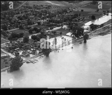 Aerial photograph of flood, unidentified stretch of lower Mississippi River.; Scope and content:  Riverside town; moderate flooding along waterfront. Stock Photo
