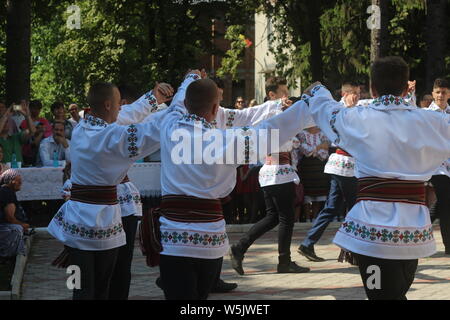 Performing folk dances in the Moldavian national costumes at the folklore festival in the village of Cotala, Moldova. Stock Photo