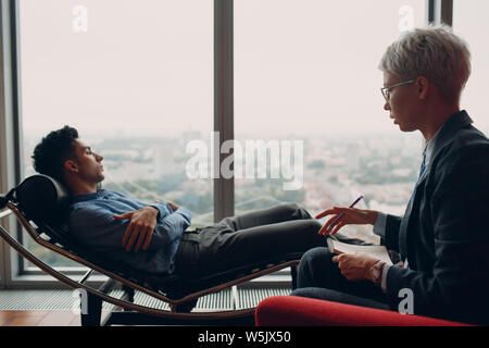 Consultation of young male patient on reception for sexologist Stock Photo