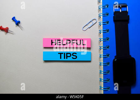 Helpful Tips text on sticky notes isolated on office desk Stock Photo