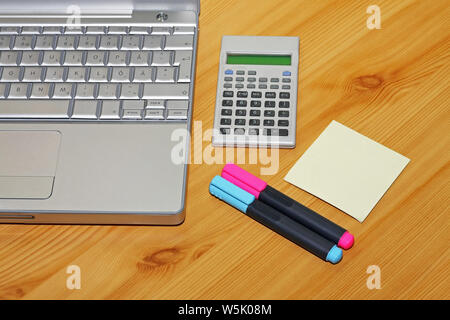 Silver Notebook Two Highlighter Pens Sticky Notes and Calculator Stock Photo