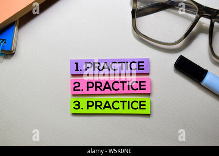 Practice. Practice. Practice text on sticky notes isolated on office desk Stock Photo
