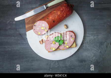 Sandwich with sausage on a marble board. Top view, copy space Stock Photo