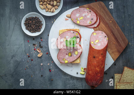 Sandwich with sausage on a marble board. Top view, copy space Stock Photo