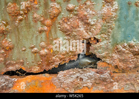 Very rusted corroded painted metal surface shot as a background Stock Photo