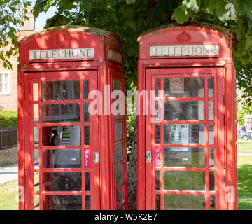 Two old style red Telephone Boxes in Broadway, Worcestershire, England, UK Stock Photo