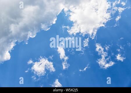 Beautiful white fluffy clouds on a deep blue sky background Stock Photo