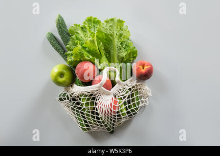 Zero waste concept. Modern shopping textile bag with fresh fruits and vegetables. View from above. Stock Photo
