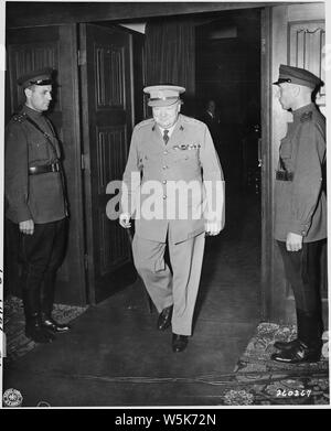 British Prime Minister Winston Churchill leaving the conference room during the Potsdam Conference in Potsdam, Germany. Soviet guards are at the entrance. Stock Photo