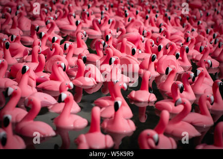 Pink plastic flamingos background texture Stock Photo