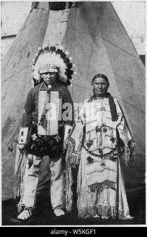 Circus Sarrasani - Two Sioux Indians in native dress in front of teepee; Scope and content:  Post card souviner of Circus Sarrasani. The caption, in English and German, reads Real Sioux Indians from Pine Ridge South Dakota. They are in Europa with Clarence Shultz, the well known cowboy from Marland Oklahoma U.S.A. Stock Photo