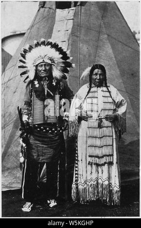 Circus Sarrasani - Two Sioux Indians in native dress in front of teepee; Scope and content:  Post card souviner of Circus Sarrasani. The caption, in English and German, reads Real Sioux Indians from Pine Ridge South Dakota. They are in Europa with Clarence Shultz, the well known cowboy from Marland Oklahoma U.S.A. Stock Photo