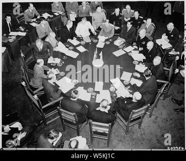 Closer view of round conference table from above, taken at the Potsdam Conference during newly elected British Prime Minister Clement Attlee's first appearance at the conference. President Truman can be seen on the right side of the photograph; Soviet Prime Minister Josef Stalin is at the top. Clement Attlee has his back to the camera. Stock Photo