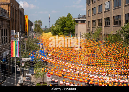 Montreal, CA - 27 July 2019: Rainbow balls art installation '18 shades of gay' on Saint-Catherine Street in the Gay Village Stock Photo