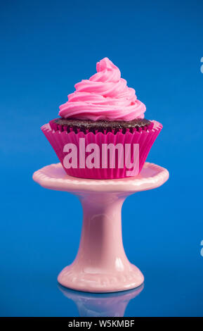 A Single Pink Cupcake on a Stand Stock Photo