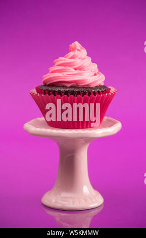 A Single Pink Cupcake on a Stand Stock Photo