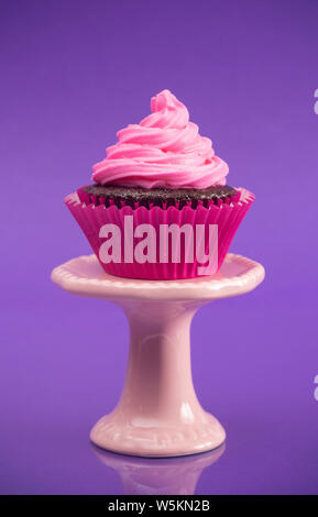 A Single Pink Cupcake on a Stand Stock Photo